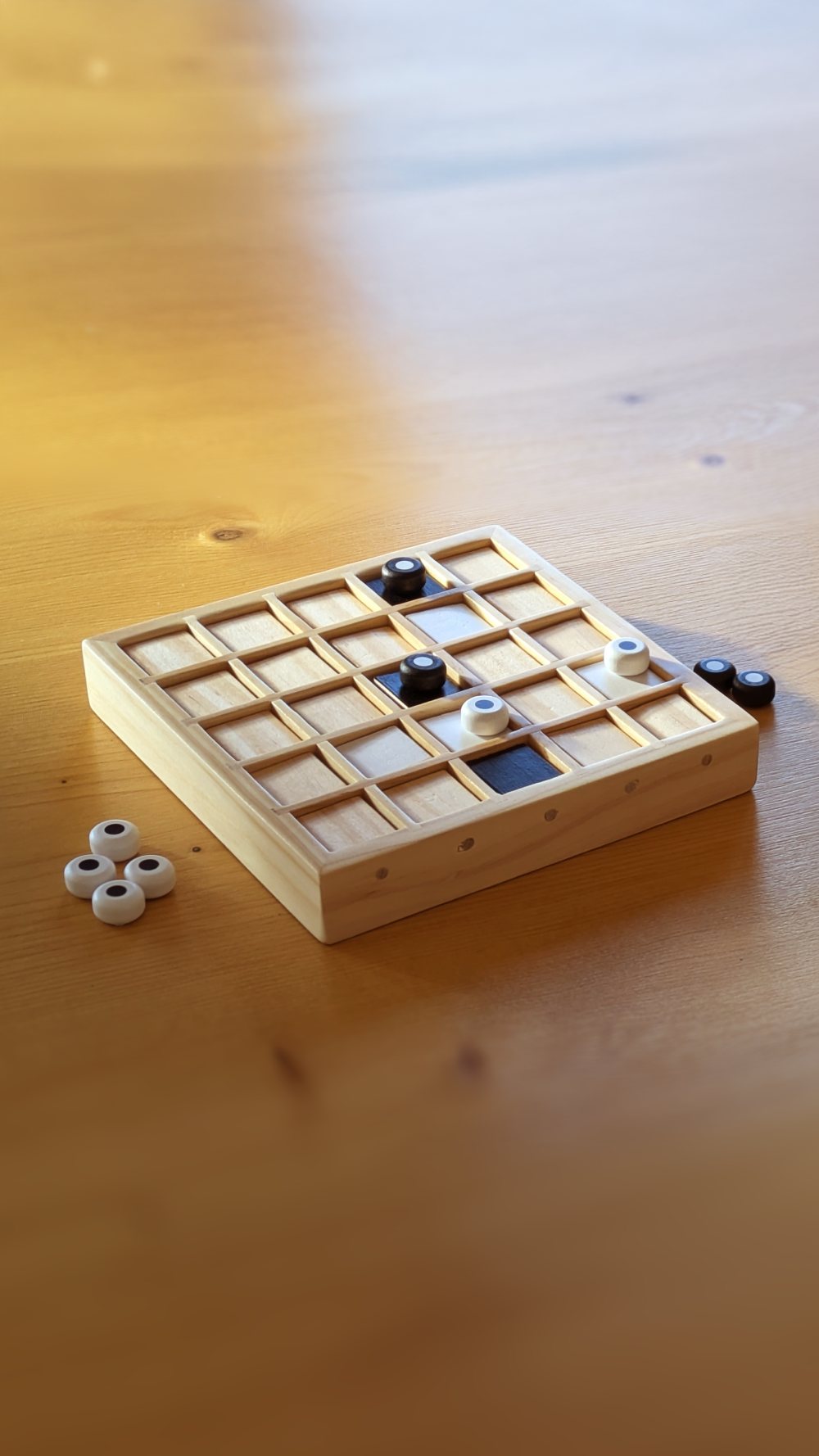 The wooden Motif board with tokens on a table